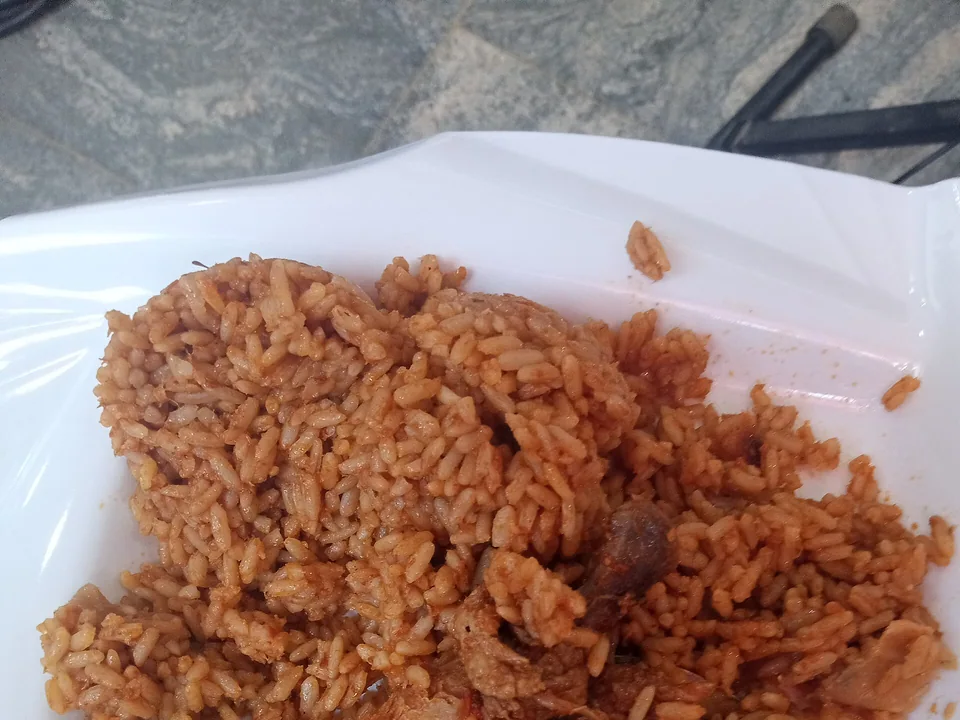 ข้าวโจลอฟไนจีเรียเมล็ดร่วนสีแดง เสิร์ฟกับมะนาวเขียว